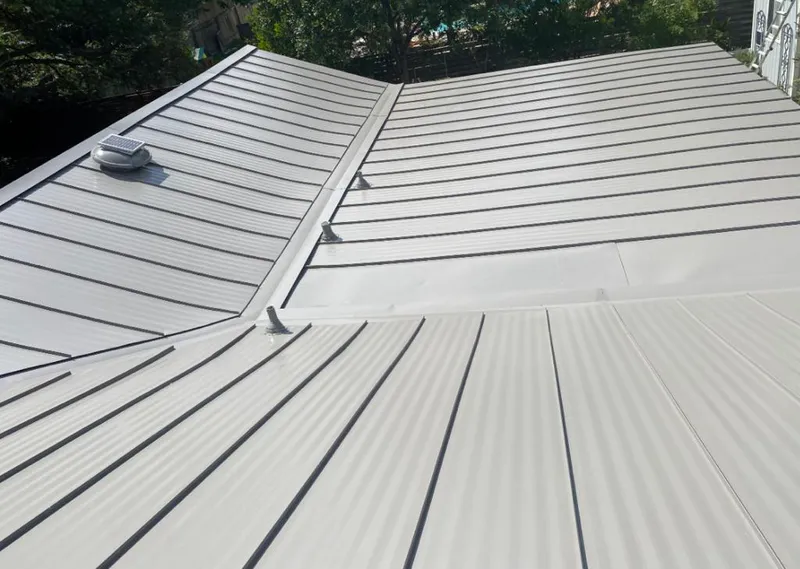 Solar attic fan installed on a metal roof for Roof Ventilation in New Brunswick
