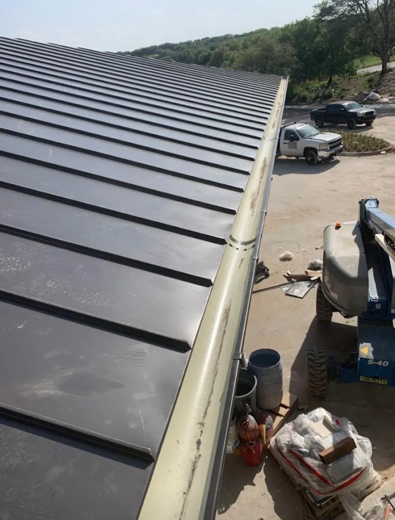 Standing seam panel and gutter detail on a metal roofing jobsite in New Brunswick